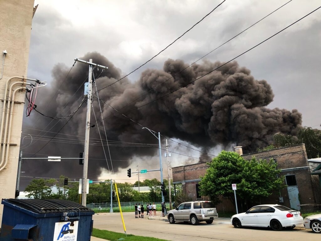 Smoke from a fire at the Nox-Crete chemical factory in South Omaha pours over Omaha as residents watch near 20th and Pierce streets.