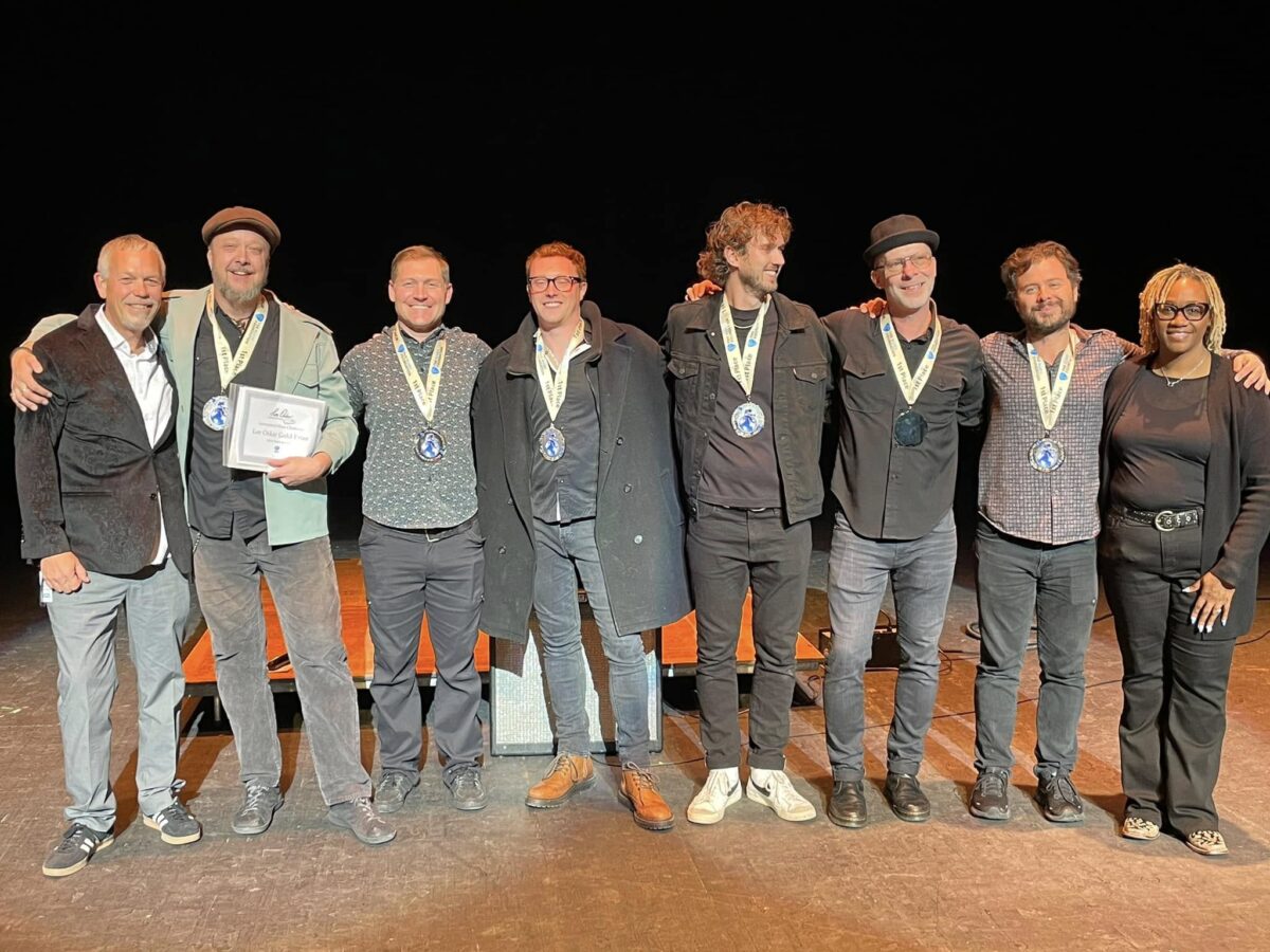 Josh Hoyer & Soul Colossal pose with their IBC medallions and representatives from The Blues Foundation.