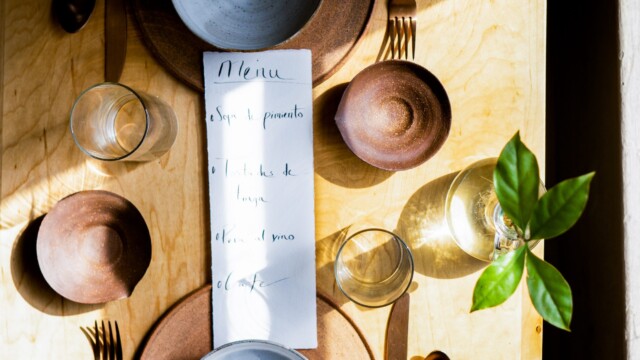 The table setting at Grainolia including handmade bowls, plates and menus from Obed Sanchez-Liborio. Photo by Chris Bowling.