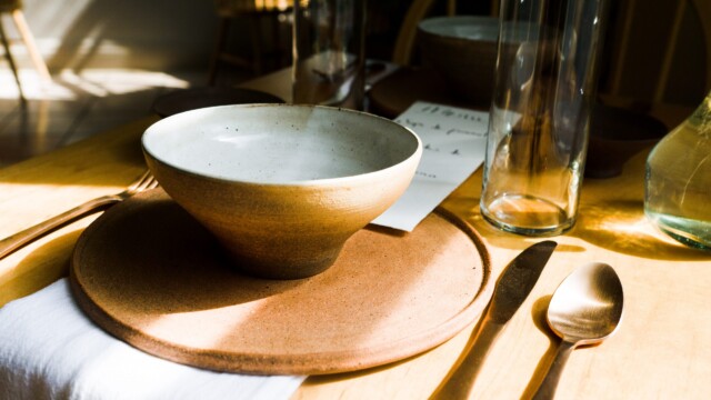 The table setting at Grainolia including handmade bowls, plates and menus from Obed Sanchez-Liborio. Photo by Chris Bowling.