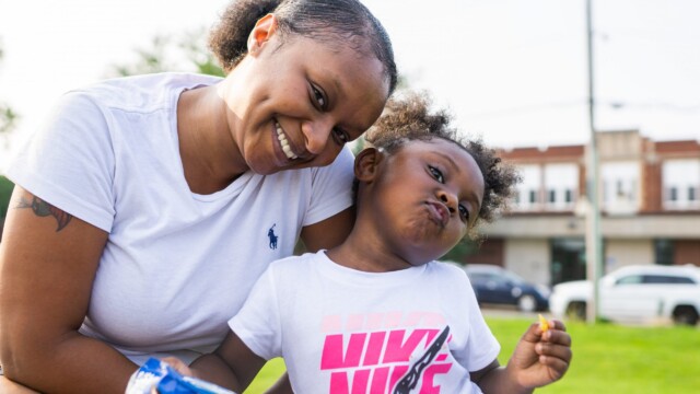 Janae Peak and her daughter smile for the camera at an Urban Flag Football League game on July 16, 2021. Photo by Chris Bowling