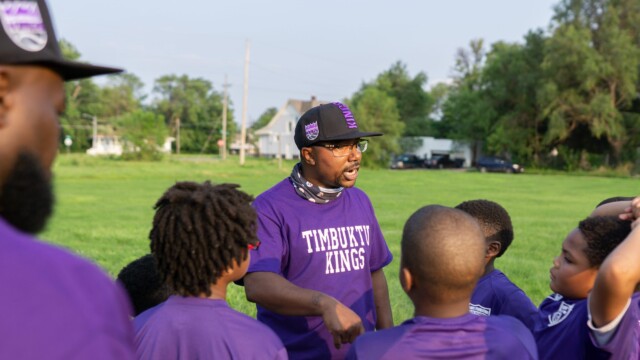 A coach talks to Urban Flag Football players on July 16, 2021. Photo by Chris Bowling.